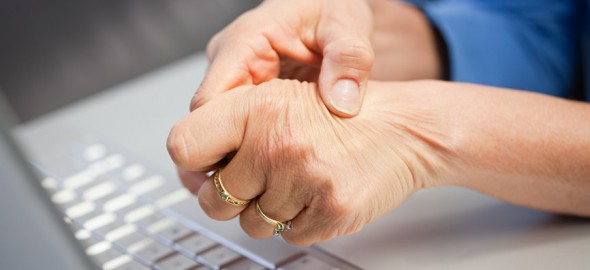 Laptop and woman with pain in hand